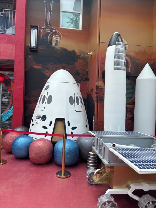 A space-themed exhibit with a space shuttle model, a rocket, and a solar panel display. - Mission to Mars (Davenport)