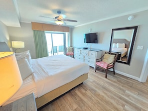 A hotel room with a bed, a desk, a chair, a TV, and a ceiling fan. - Stay at the top of the world with Penthouse level views! 3BR\Bath Oceanfront (Myrtle Beach)