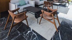 A modern lounge area with a sofa set, coffee table, and chairs, wooden panel walls, and a ceiling with a blue grid pattern. - OH | Amazing Loft Roma Nte w/ AC (Mexico City)