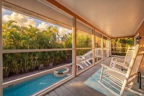 A poolside area with a view of tropical vegetation, a hot tub, and outdoor seating. - Slip into island time the moment you arrive at Poppy’s Paradise (Captiva)