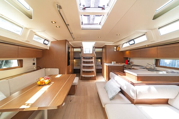 A compact interior with a dining area, kitchenette, and seating.
