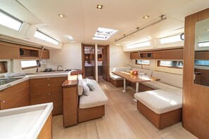 A modern interior with a kitchen area, seating, and a dining space.