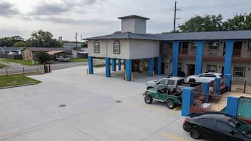A building with a garage, a parking lot, and a street view.