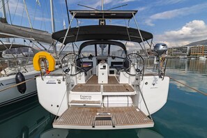 A yacht with a covered cockpit, a steering wheel, and a brand name 'Jeanneau' on the bow. - Sun-Kissed Sailing Adventure in the Sporades Islands from Volos, Thessaly (Volos)