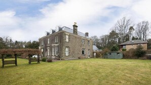A stone building with a large lawn in front. - OYO Ashlea Manor (Dundee)