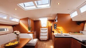 A compact kitchen with a central island, built-in appliances, and a skylight.