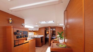 A compact kitchen with a central island, built-in appliances, and a small dining area.