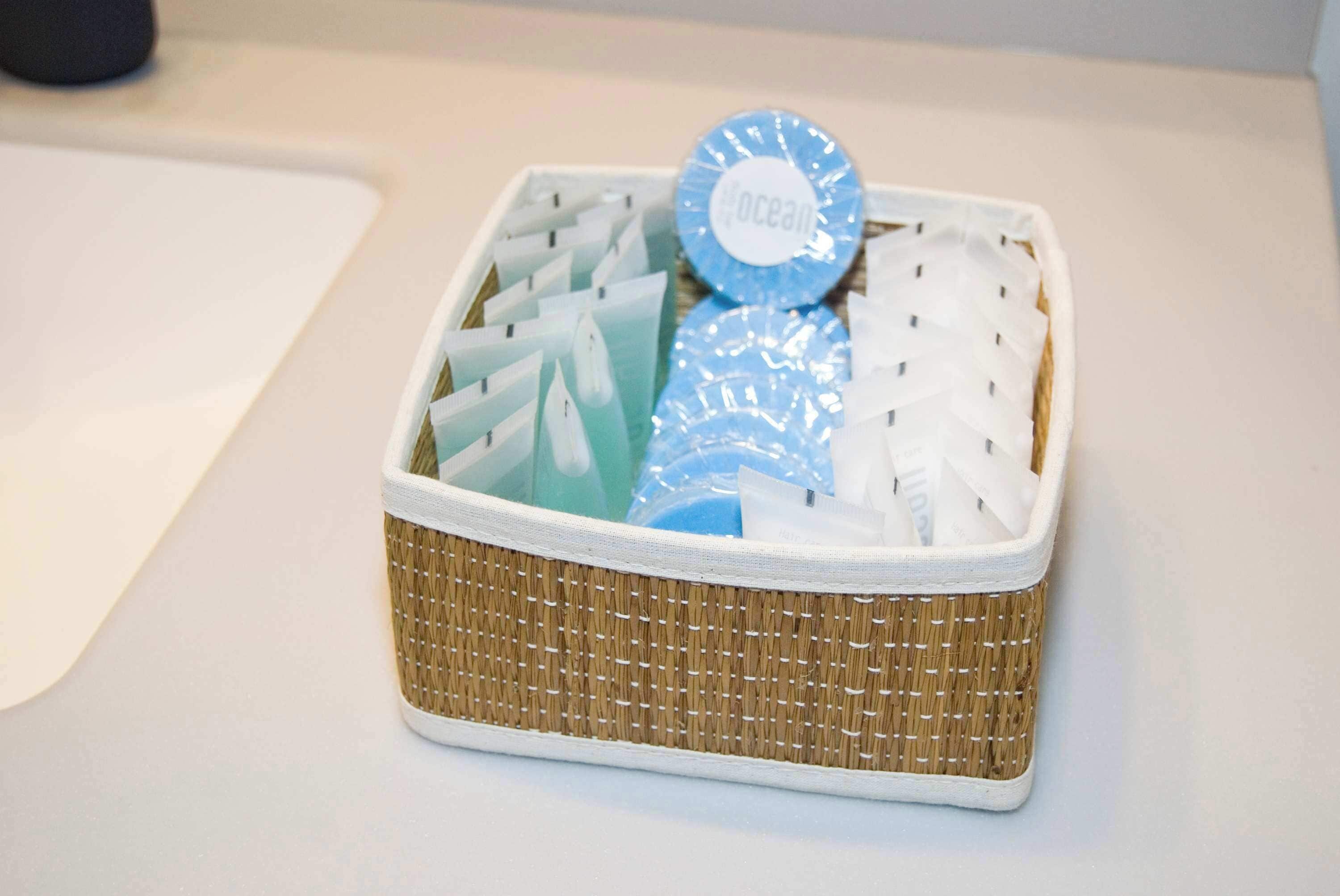 A wicker basket containing various items, including a blue circular object with the word 'ocean' on it.