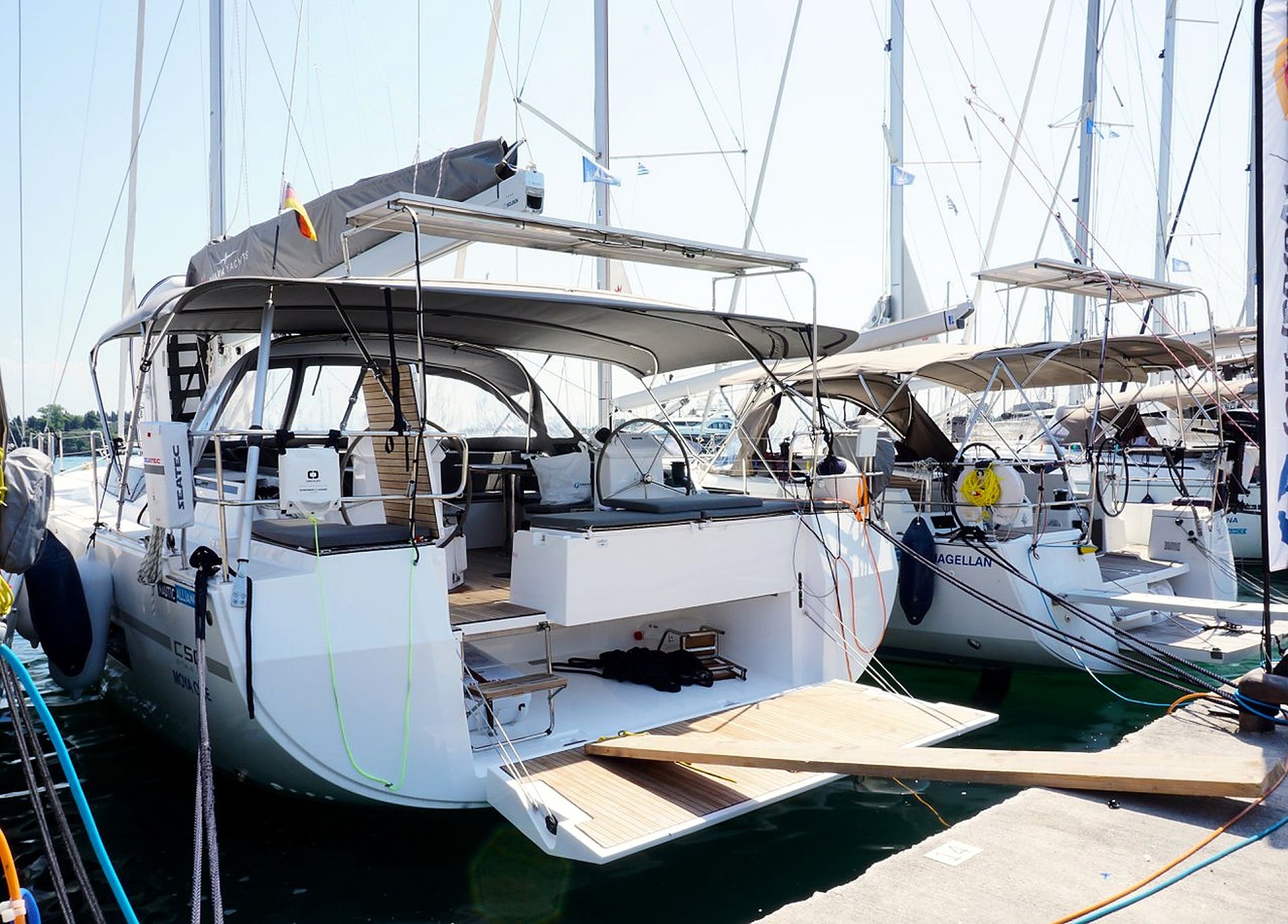 A marina with multiple sailboats docked.