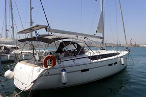 A white yacht docked at a marina with a covered cockpit, lifebuoy, and a clear view of the water and other boats. - Sun-Kissed Sailing Adventure in the Sporades Islands from Volos, Thessaly (Volos)