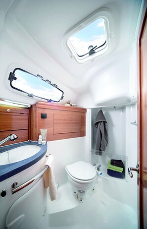 A compact bathroom with a built-in window, a sink, and a toilet. - Sun-Kissed Sailing Adventure in the Sporades Islands from Volos, Thessaly (Volos)