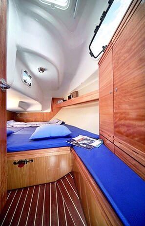 A compact cabin with a single bed, a small table, and a window. - Sun-Kissed Sailing Adventure in the Sporades Islands from Volos, Thessaly (Volos)