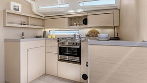 A compact kitchen with a built-in oven, wooden cabinets, and a window above the sink.