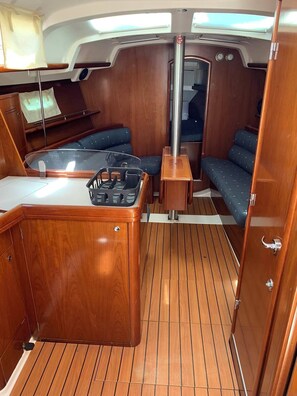 A compact interior with a wooden bar, seating, and a control panel.