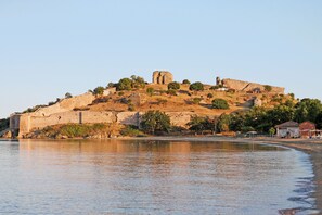 A historic fortification with ruins on a hill overlooking a body of water. - Sun-Kissed Sailing Adventure in the Saronic Islands (Nea Peramos)