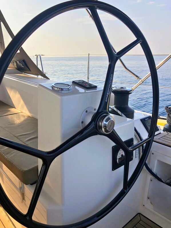 Timón, panel de control y parte de la cubierta de un barco.