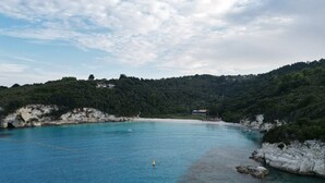 A coastal landscape with clear blue waters, rocky shorelines, and a hilly backdrop. - Sun-kissed Sailing Adventure in the Ionian Islands (Preveza)