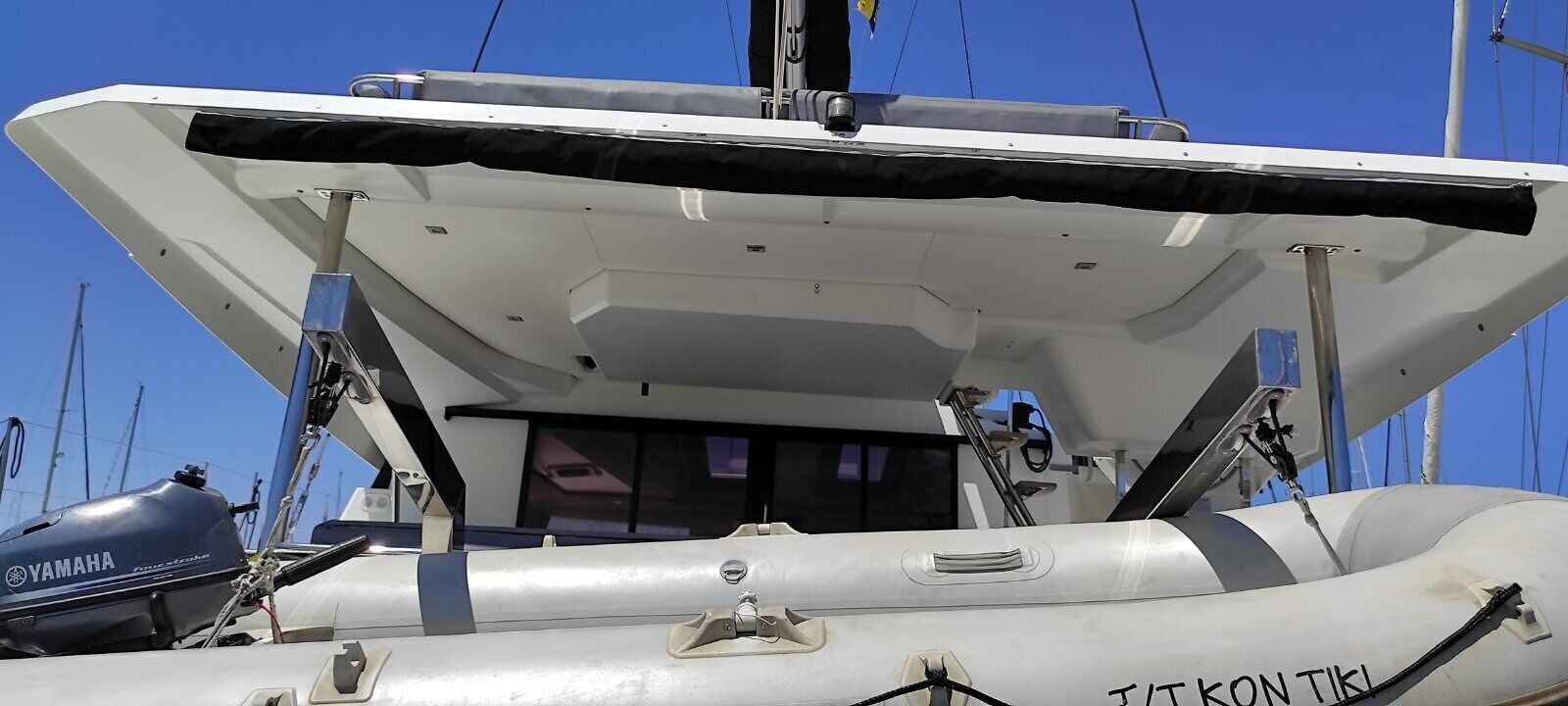 A boat with a Yamaha outboard motor, a cabin, and the name 'TIKON TIKI' on the side.