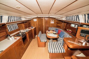 A compact, well-appointed interior with a kitchenette, seating area, and a control panel. - Sun-Kissed Sailing Adventure in Islas Sarónicas (Alimos)