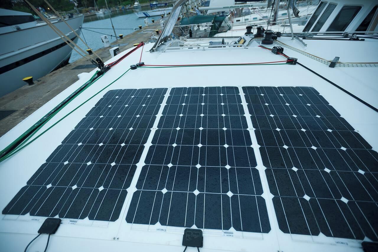 A boat with a solar panel array on the deck.