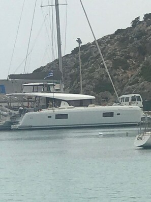 A white yacht docked at a marina with a rocky hill in the background. - Sun-Kissed Sailing Adventure in the Ionian Islands, Lefkada (Lefkada)