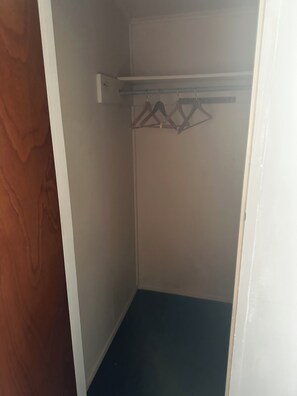 A small, enclosed closet with a single rod for hanging clothes. - GREY STREET HAVEN!
Relax and unwind in this peaceful home, (Rotorua)