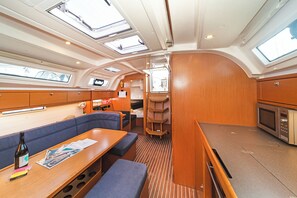 A compact galley with a dining area, a microwave, and a small kitchenette.