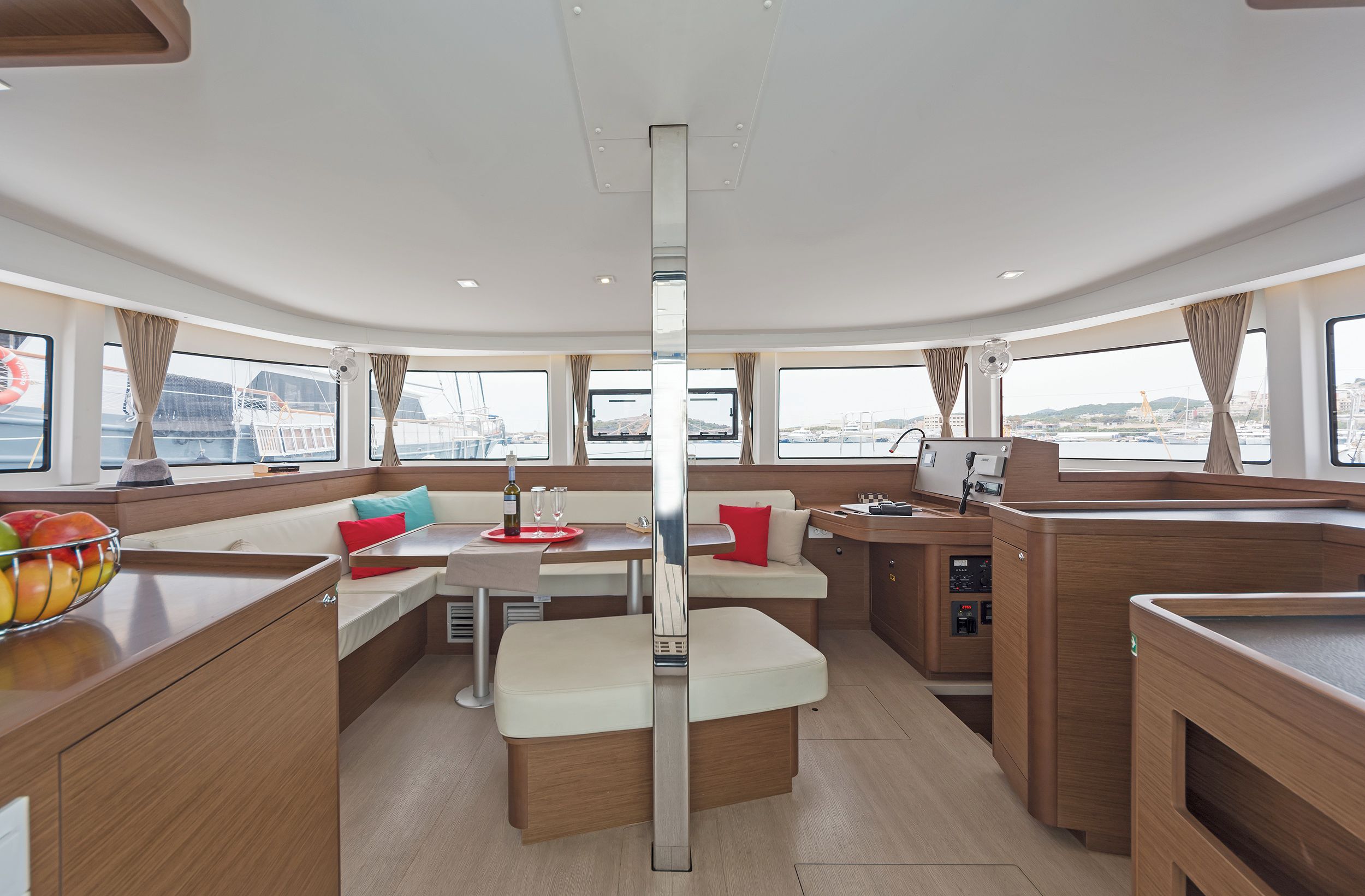 L'intérieur d'un bateau comprend un espace repas, des sièges et un panneau de commande.
