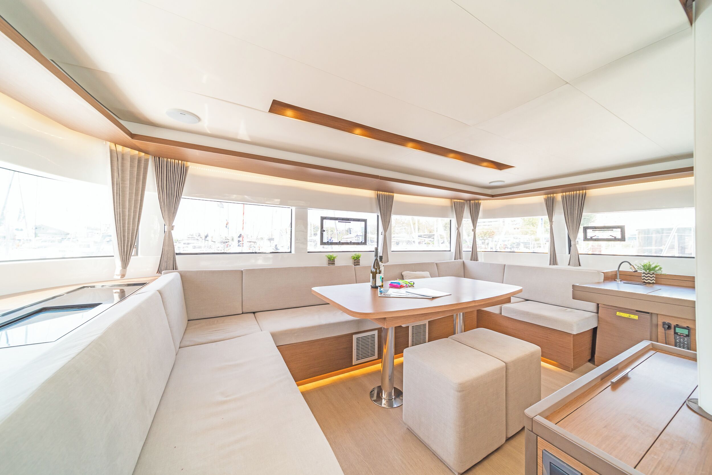 A modern interior with a dining area, seating, and a kitchenette.