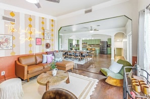 A spacious living area with a sofa, coffee table, and a dining set. - Private Resort | 4 Baths Near Pearl (San Antonio)