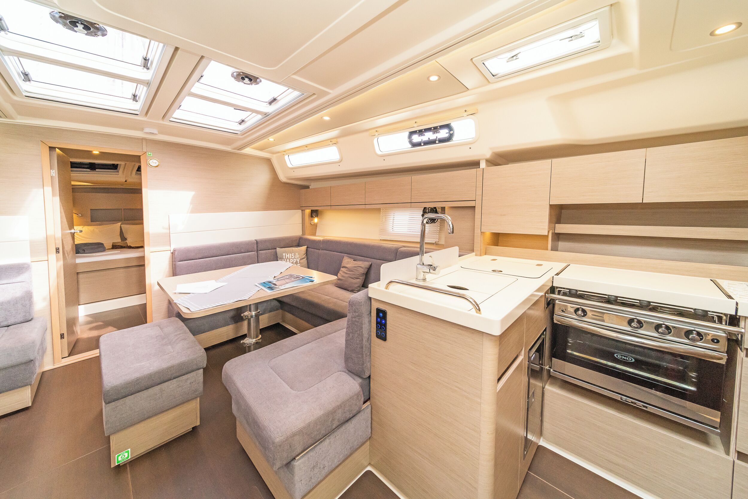 A compact galley with a stove, a small dining table, and seating.