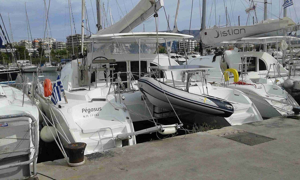 Una marina con diverse imbarcazioni ormeggiate, tra cui una chiamata 'Pégasus' e un'altra con la scritta 'Jistion'.