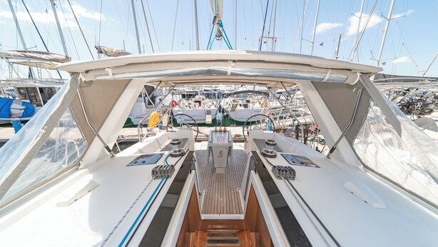 A boat deck with a steering wheel, throttle, and various controls. - Sun-Kissed Sailing Adventure in Islas Sarónicas (Alimos)