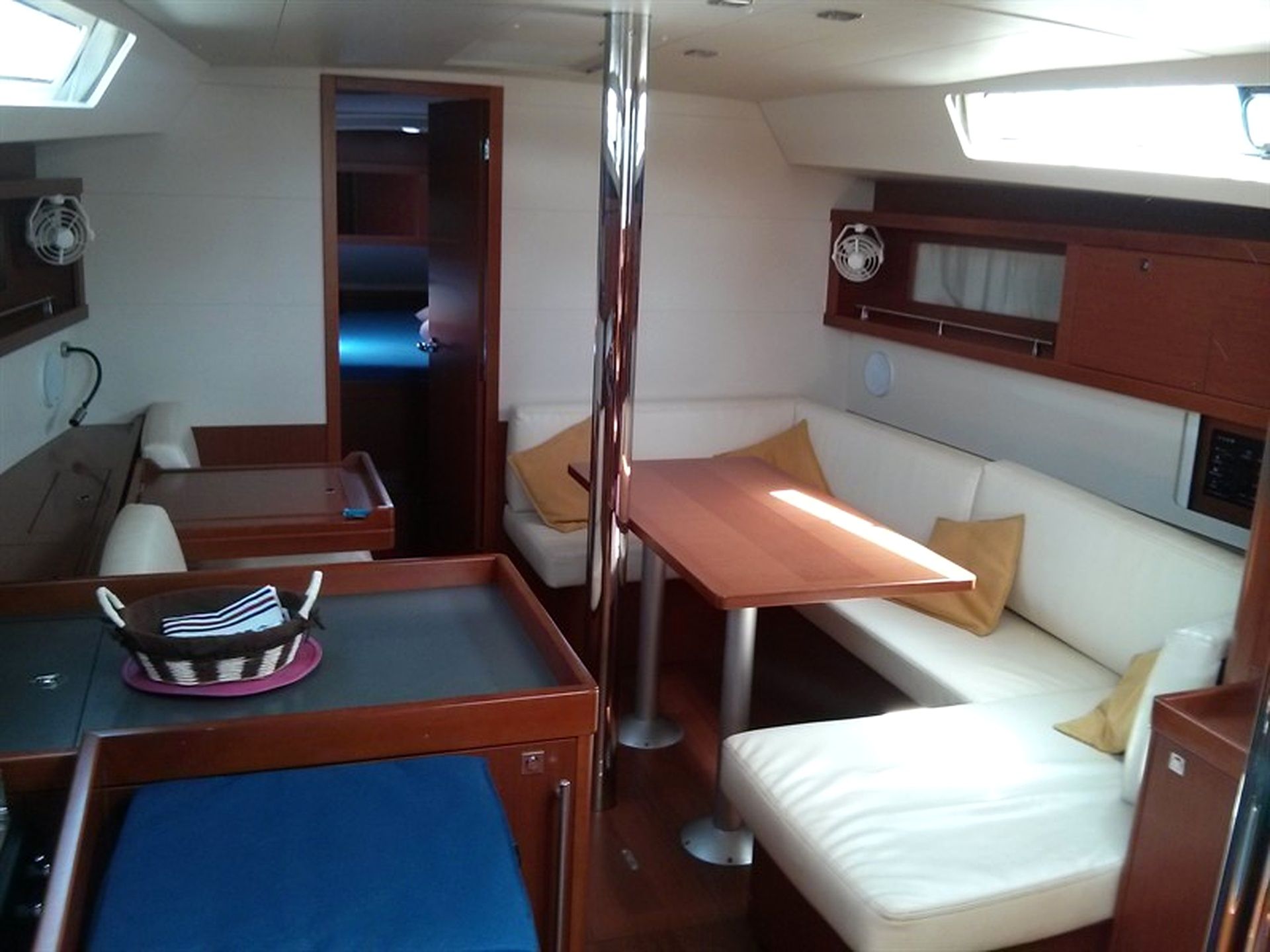 A compact interior with a dining area, a sofa, and a small table.