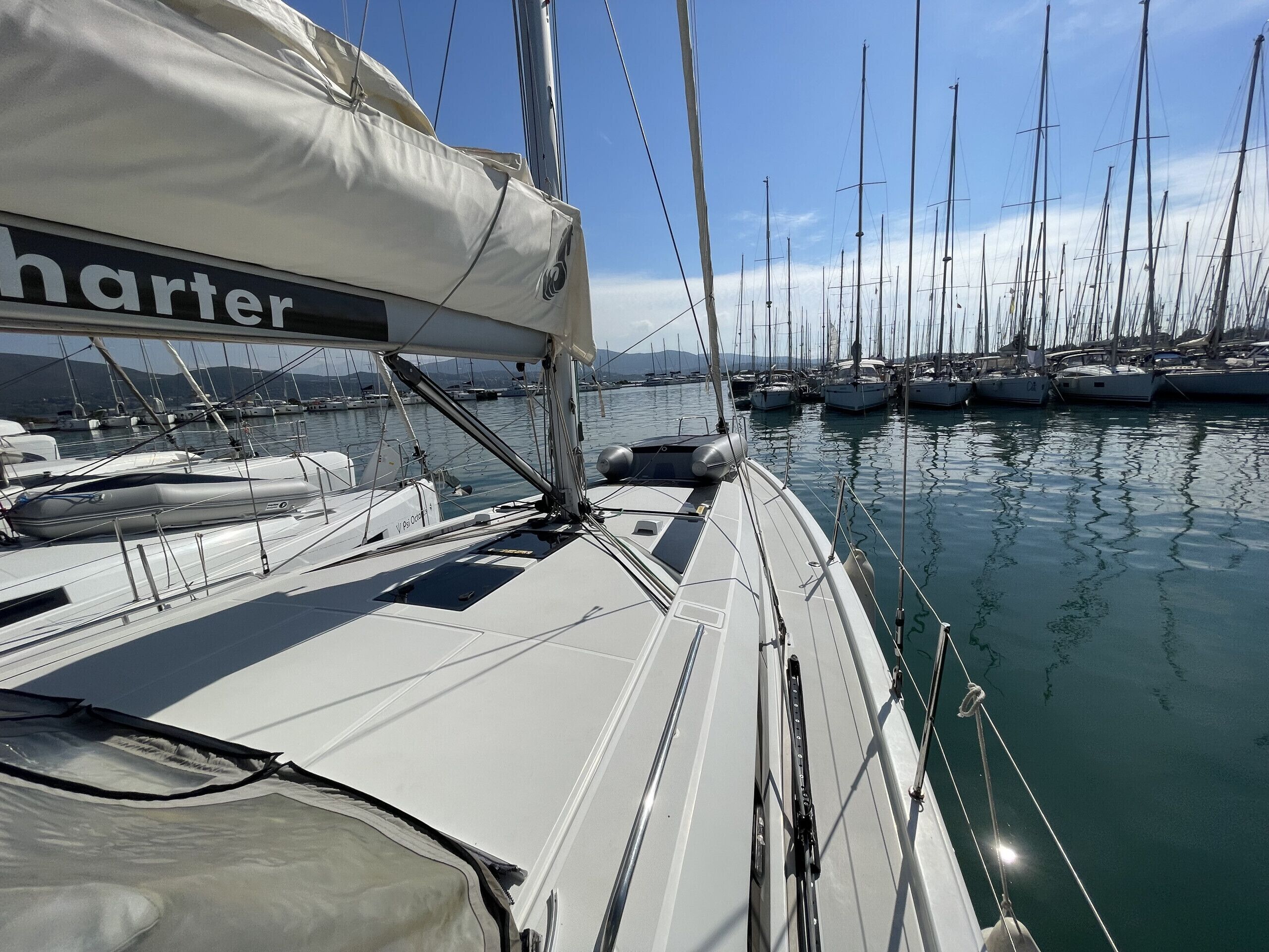 A marina with multiple sailboats docked.