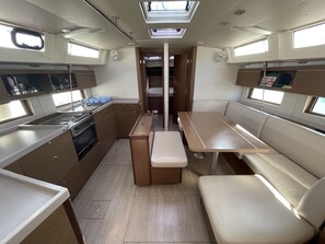 A compact kitchen with a stove, sink, and storage cabinets. - Sun-Kissed Sailing Adventure in the Ionian Islands, Lefkada (Lefkada)