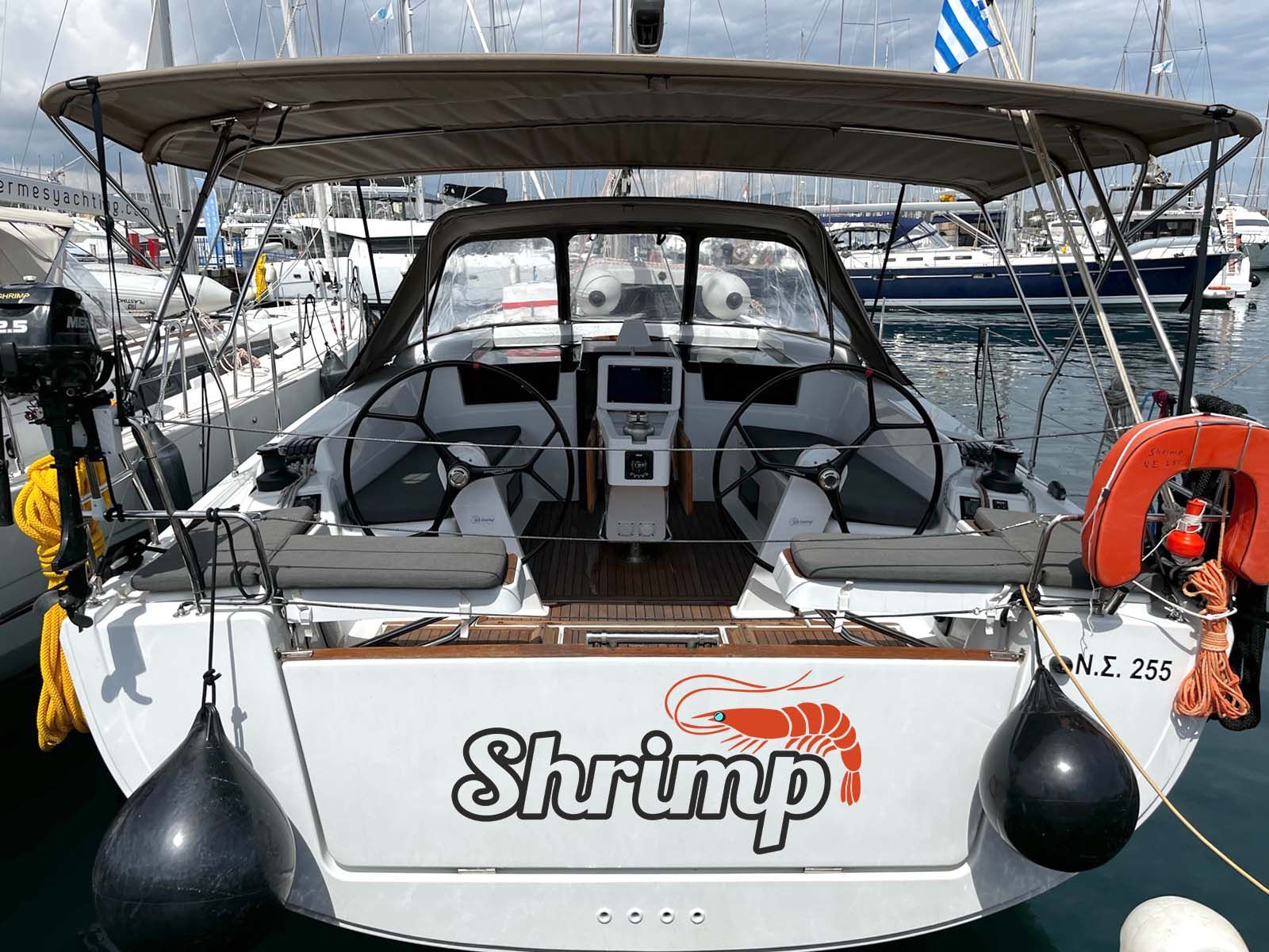A boat with a 'Shrimp' logo, a steering wheel, and a life buoy.