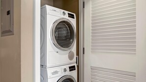 A stacked washer and dryer unit in a laundry room. - Honua Kai 2 Free Rental Cars KBM Resorts Gorgeous Inner Courtyard 2 Units, 4 Bedrooms HK Ml-2780 (Kaanapali)