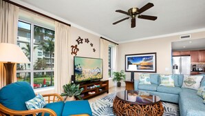 A living room with a television, sofa, and a ceiling fan. - Honua Kai 3 Free Cars KBM Resorts Front Alii Suite 3 Units, 6 Bedrooms HK Ml-3146 (Kaanapali)