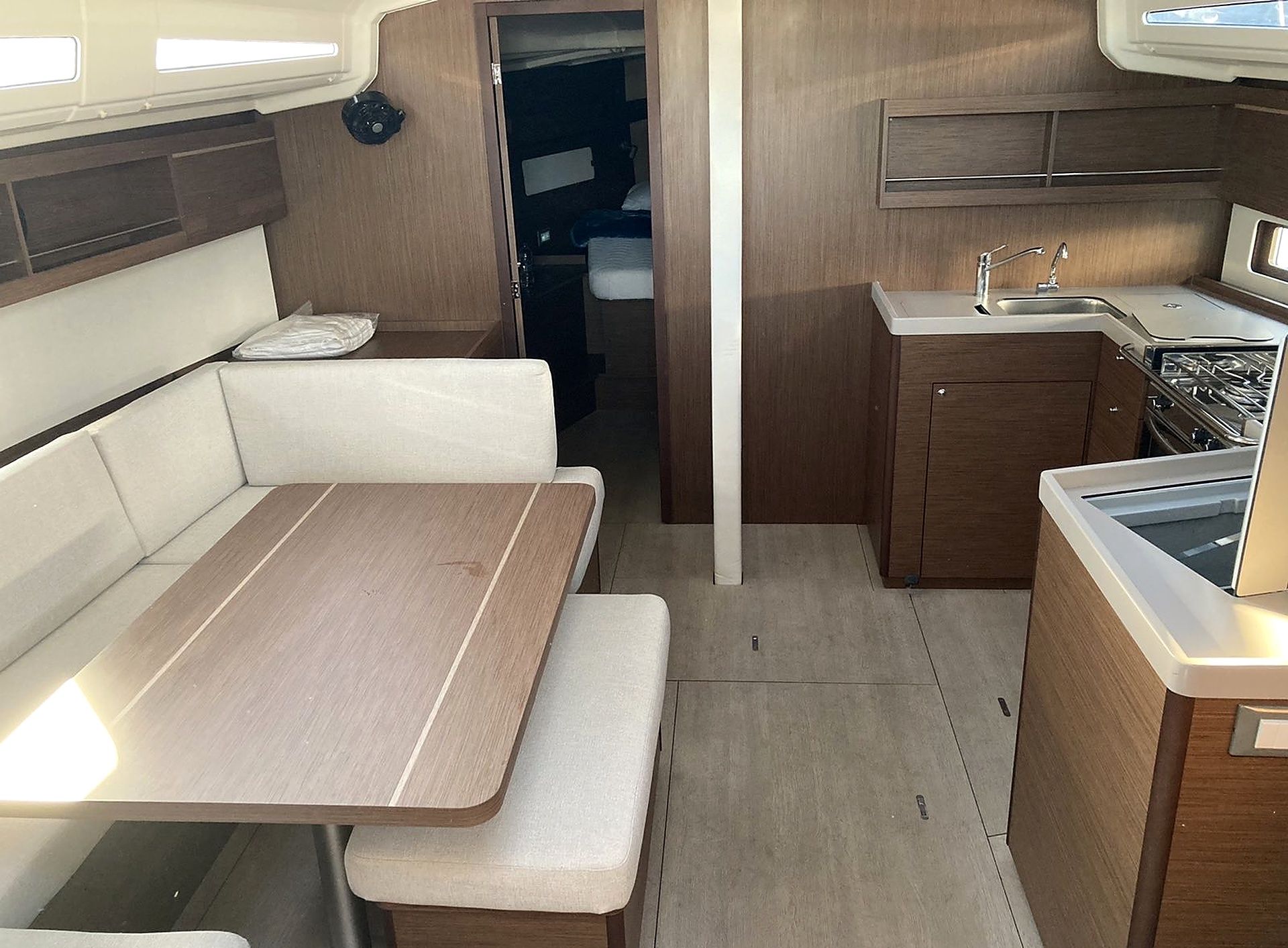 A compact kitchenette with a stove, sink, and storage cabinets.