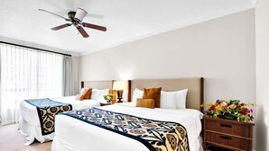 A hotel room with two beds, a ceiling fan, a nightstand with a lamp, and a flower vase. - Honua Kai 4 Free Cars KBM Resorts Front Alii Suite 4 Units, 8 Bedrooms HK Ml-3182 (Kaanapali)