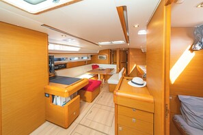 A compact interior with a kitchenette, seating area, and a bed.
