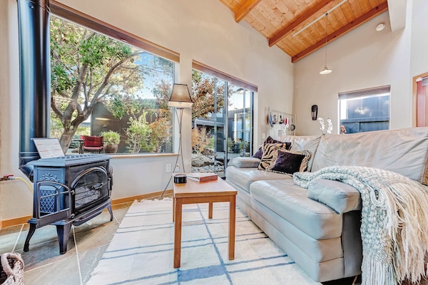 Cozy up by the gas fireplace as natural light pours into the living room, creating a warm and inviting space.