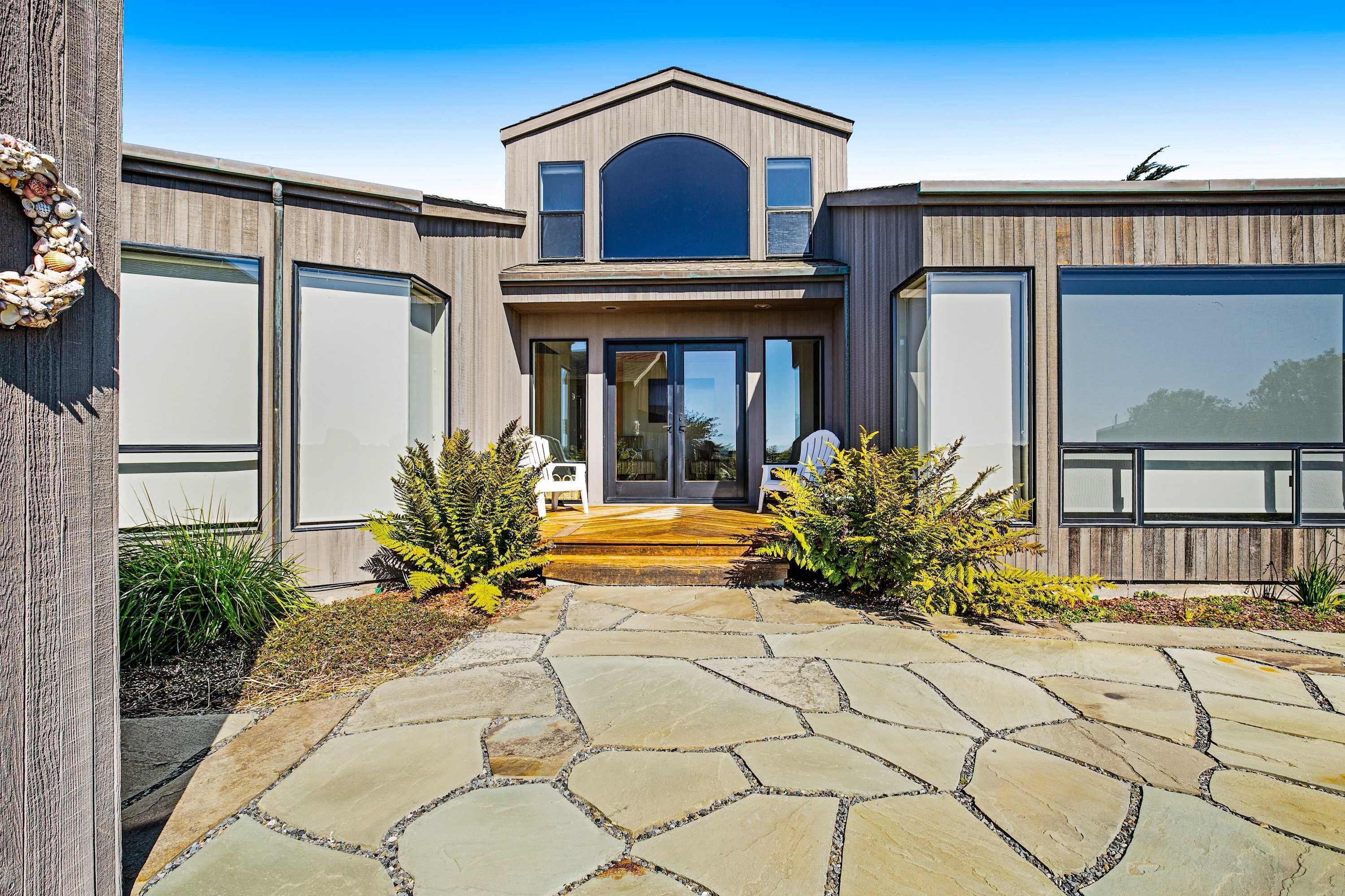 The striking front entrance showcases modern architecture, inviting you to experience the comfort and style that awaits inside.