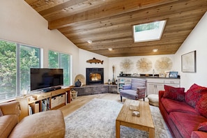 A living room with a television, fireplace, and seating area. - Meadow home with private hot tub near Black Point Beach (Sea Ranch)