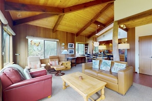 A spacious living area with a high wooden ceiling, leather sofas, a wooden coffee table, and a view of the kitchen and dining area. - Classic Sea Ranch Home With Updated Amenities. Hot Tub. 1 Dog Allowed (Sea Ranch)
