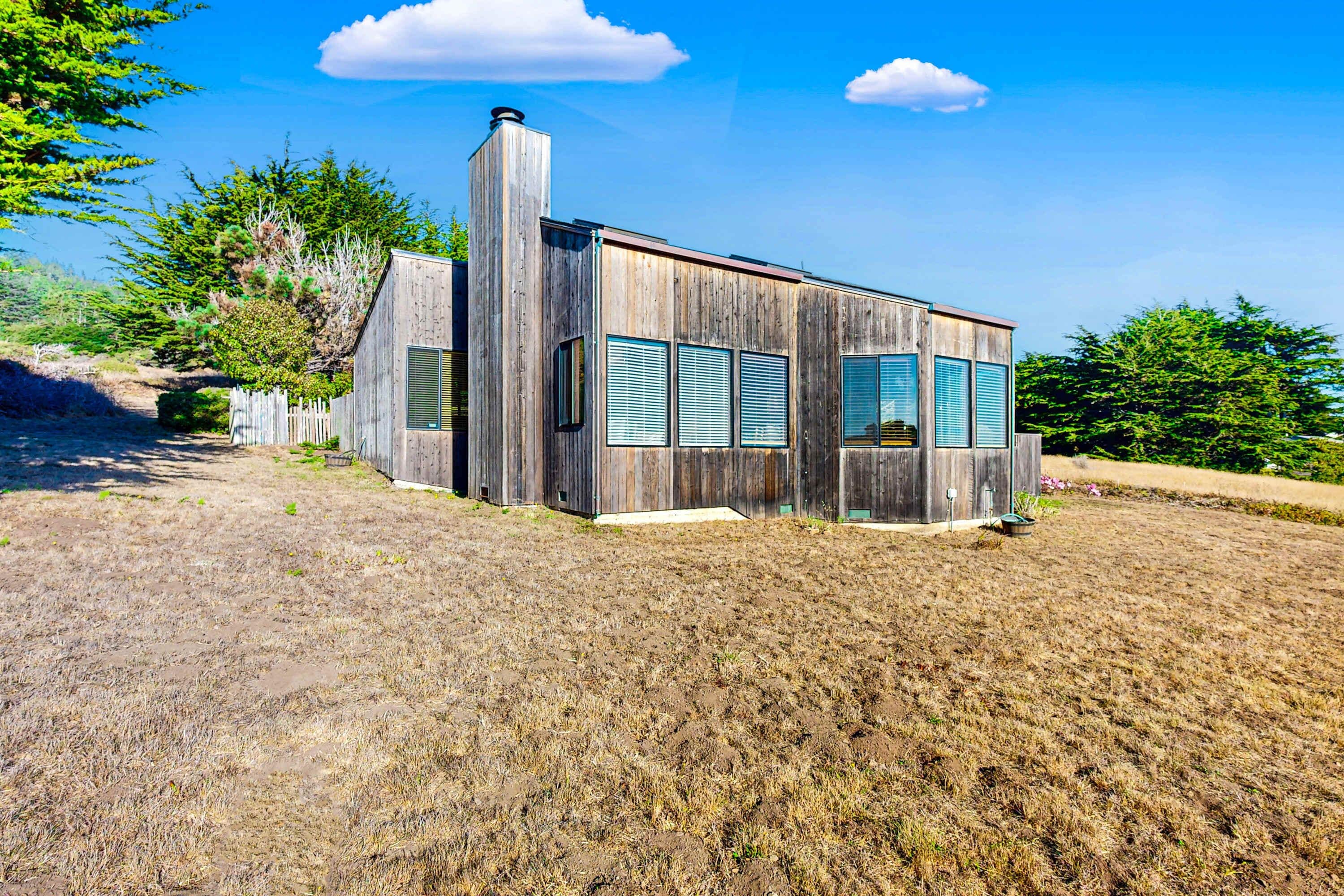 Experience the charm of Clemons' Cottage from the outside, featuring a unique design that blends seamlessly with the beautiful coastal landscape.
