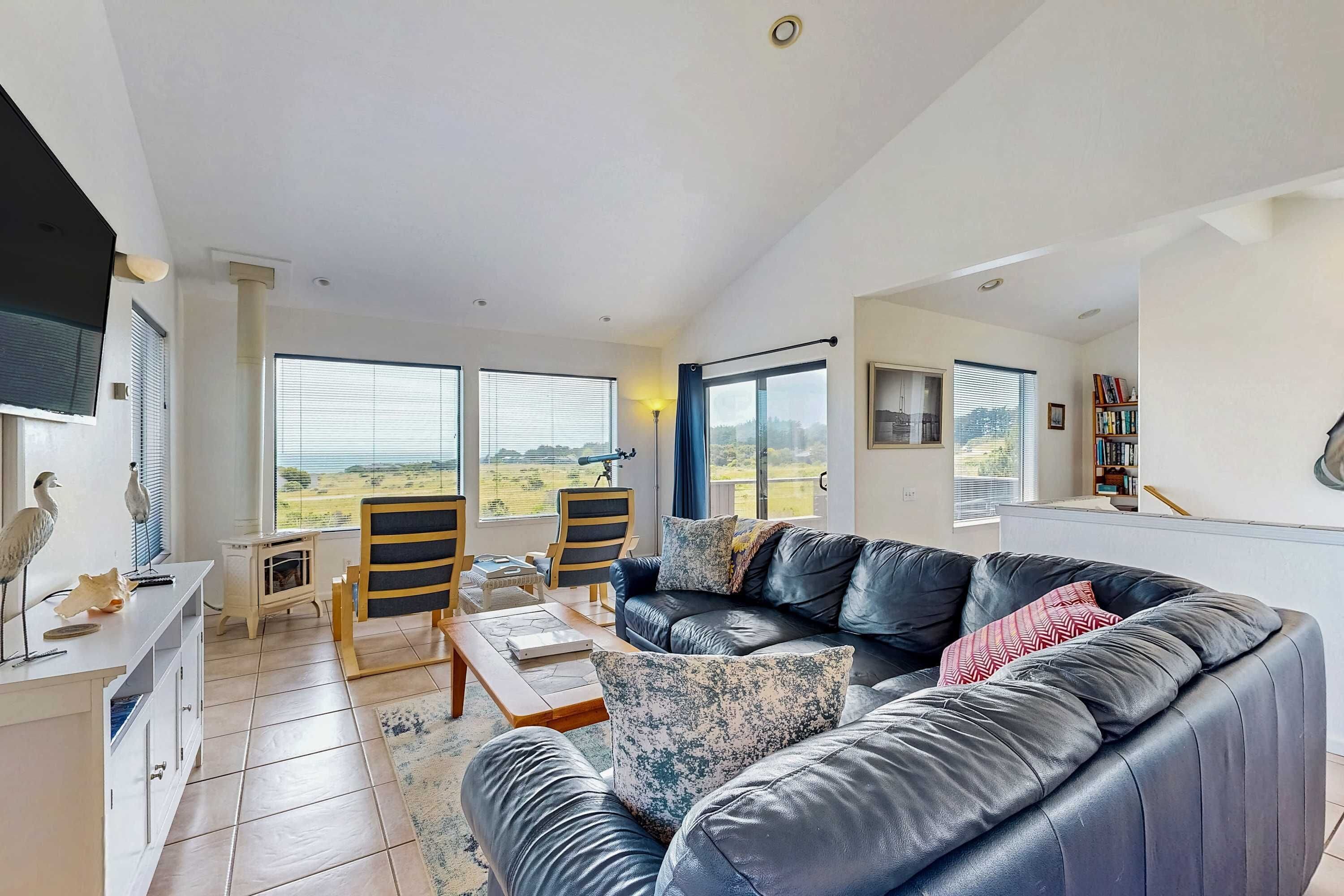 Morning light fills the spacious living room, creating a cozy spot to unwind while you gaze at the breathtaking ocean views.