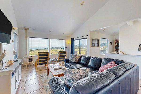 Morning light fills the spacious living room, creating a cozy spot to unwind while you gaze at the breathtaking ocean views.