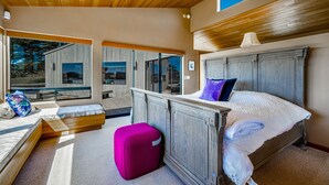 A bedroom with a large bed, a wooden headboard, a window, and a view of the outdoors. - Coastal Luxury: Chef Kitchen, Ocean Views, Hot Tub (Sea Ranch)